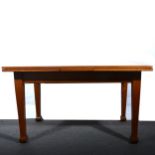 An oak draw-leaf dining table.