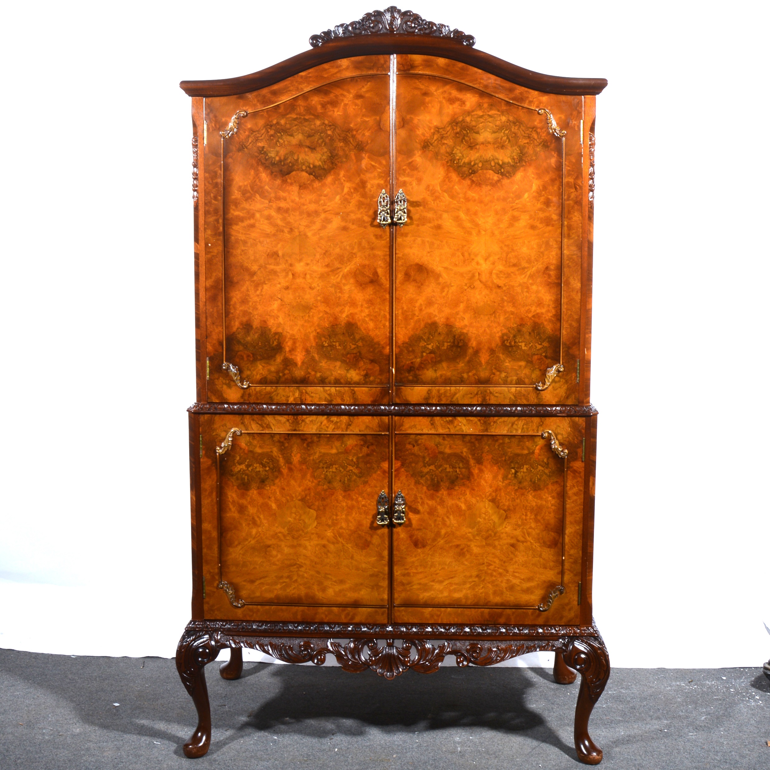 A reproduction burr walnut cocktail cabinet, Queen Anne style.