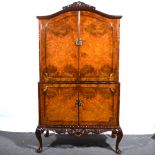 A reproduction burr walnut cocktail cabinet, Queen Anne style.