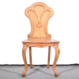 A Victorian oak hall chair.