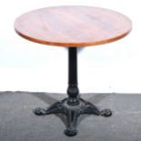 A reproduction cast iron pub table, and an oak stool.