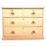A stripped pine chest of drawers.