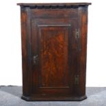 An oak hanging corner cupboard.