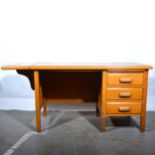 Two light oak office tables/ desks, early 20th century.