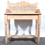 A stripped pine washstand with tile back.