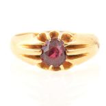 A claw set garnet dress ring, marked 18ct.