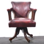 An Edwardian leather-upholstered swivel office chair.