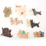 Eight vintage celluloid and plastic Scottie dog brooches, five with articulated heads.