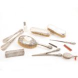 A collection of silver and white metal vanity items, to include brushes, combs, shoe horns, etc.