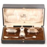 Three-piece silver condiments set by Walker & Hall, Birmingham 1932, cased.