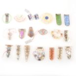 Eighteen mostly clear glass brooches and dress clips, pair of earrings, painted decoration.