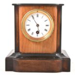 A Victorian walnut and ebonised mantel clock.