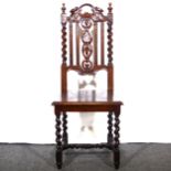 A carved oak and barley twist hall chair.