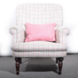 A modern armchair, pink and grey checked woollen upholstery.