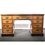 An Edwardian oak and grained walnut bowfront dressing table.