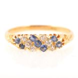 A diamond and blue stone half hoop dress ring.