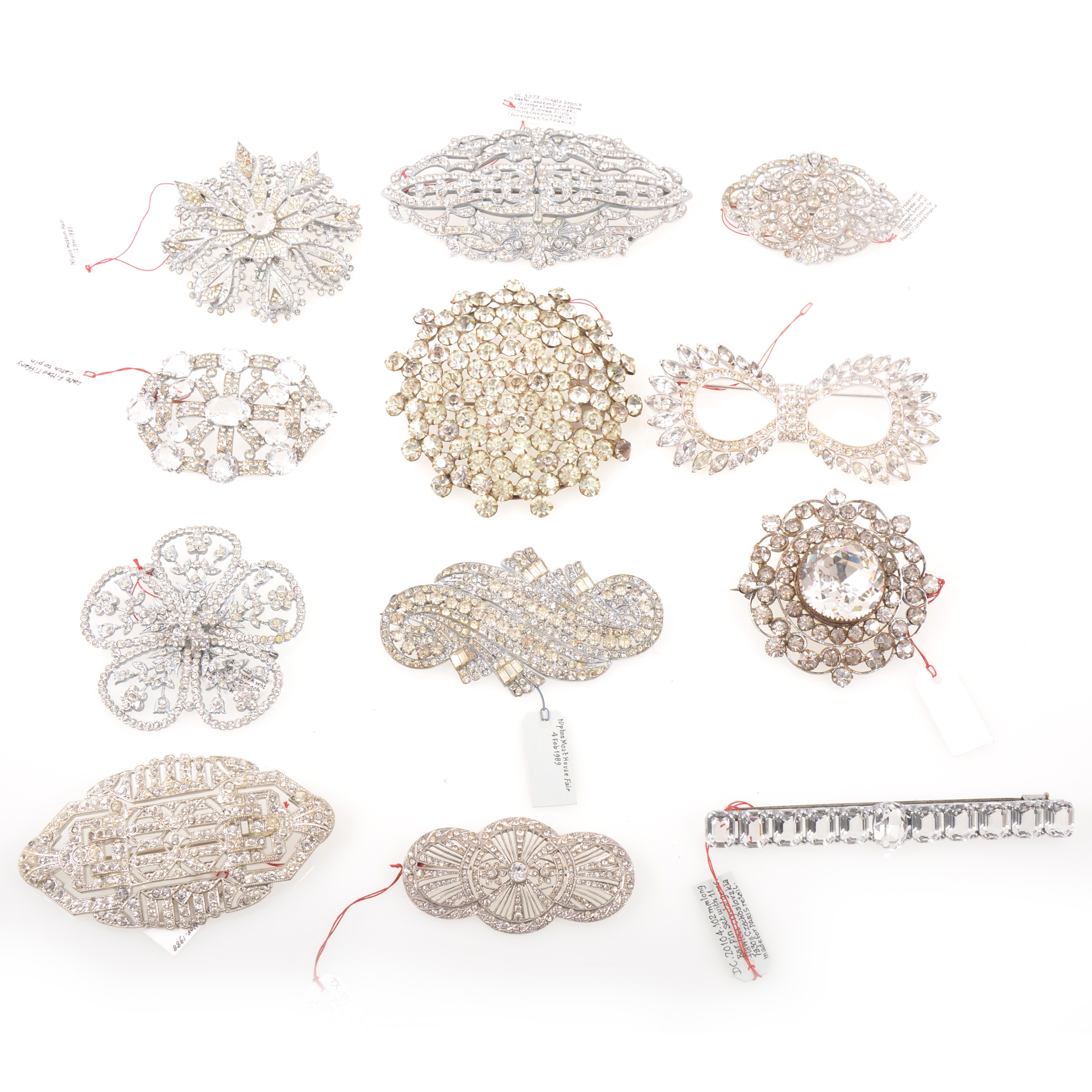 Twelve large clear paste costume jewellery brooches, vintage circa 1930, floral and Deco designs.