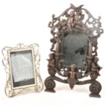 Bronzed dressing table mirror and a small plated photo frame.
