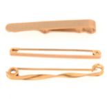 Two gold bar brooches/stocks and a tie bar,