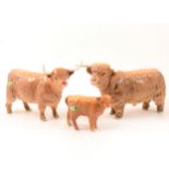 A Beswick Highland Bull, Cow and Calf models.