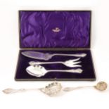 A cased three piece set of plated fish servers and two ornate silver serving spoons.