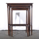 A nest of three inlaid mahogany occasional tables.