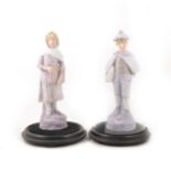 A pair of Continental bisque porcelain figures.