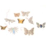 Nine 1930's coloured and clear paste butterfly brooches.