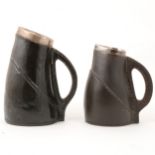 Two similar Doulton Lambeth stoneware 'black jack' jugs with silver mounts