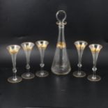 Continental glass decanter and five flutes.