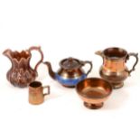 Four pieces of copper lustre glazed pottery and a treacle glazed jug.