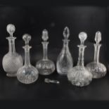 Pair of cut glass globe and wand decanters and four others,