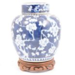 Chinese porcelain blue and white ginger jar and cover, on a hardwood stand.