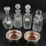 Four glass decanters with pair of electroplated coasters and Royal Staffordshire labels.