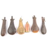 Embossed brass shot flask, copper shot flask, and four other powder pouches