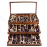 Collection of Georgian and later shoe and breeches buckles in a three tier concertina display case.