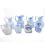 Eight assorted Victorian relief-moulded decorative jugs.