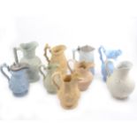 Nine assorted Victorian relief-moulded decorative jugs.