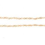 A yellow metal figure of eight link necklace testing as gold.