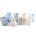 Eight Victorian relief-moulded jugs.