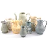 Eight Victorian relief-moulded jugs.