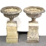 Set of four cast stone campana garden urns,