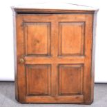 An old oak corner cupboard,