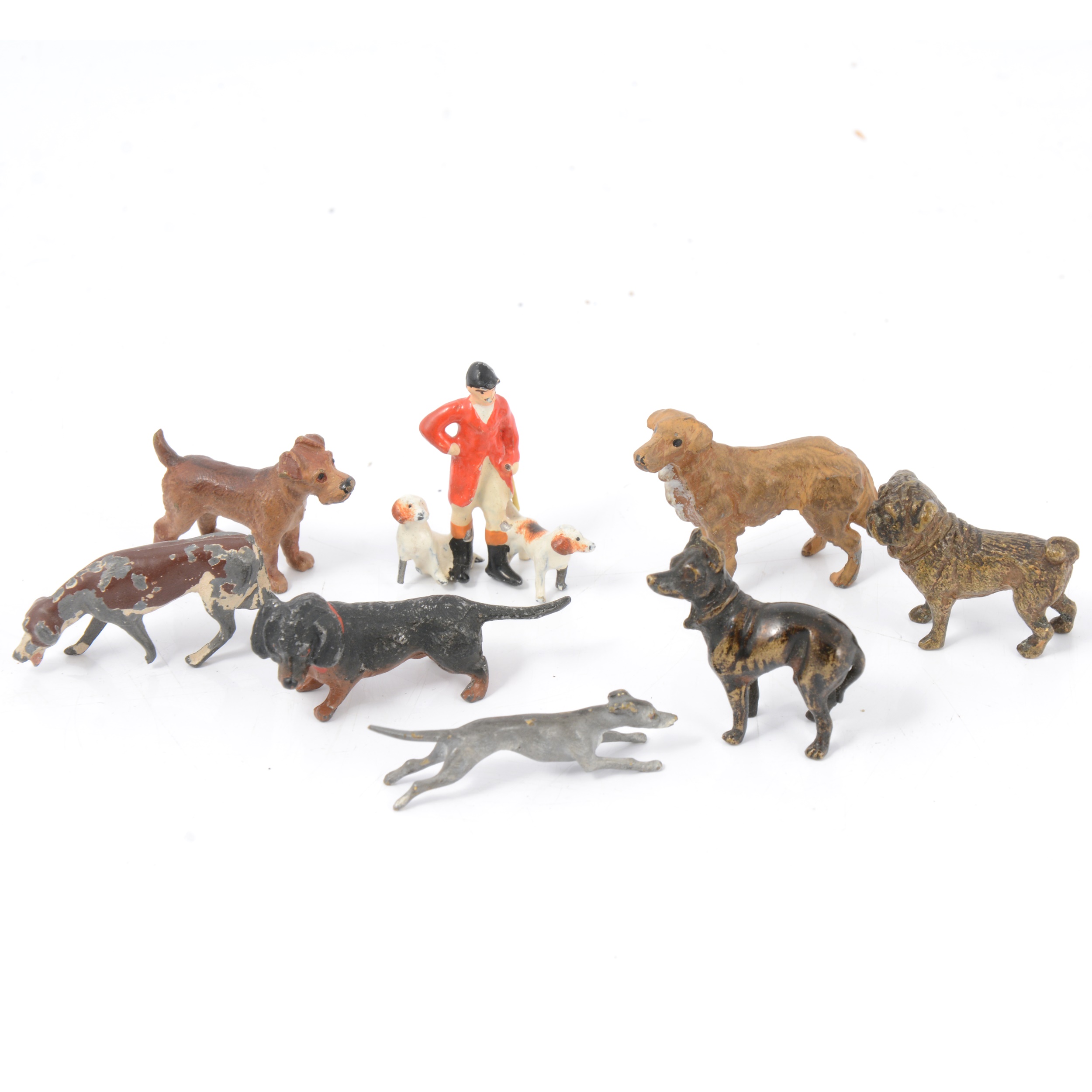 Eight miniature cold-painted bronze and white metal dog figures.