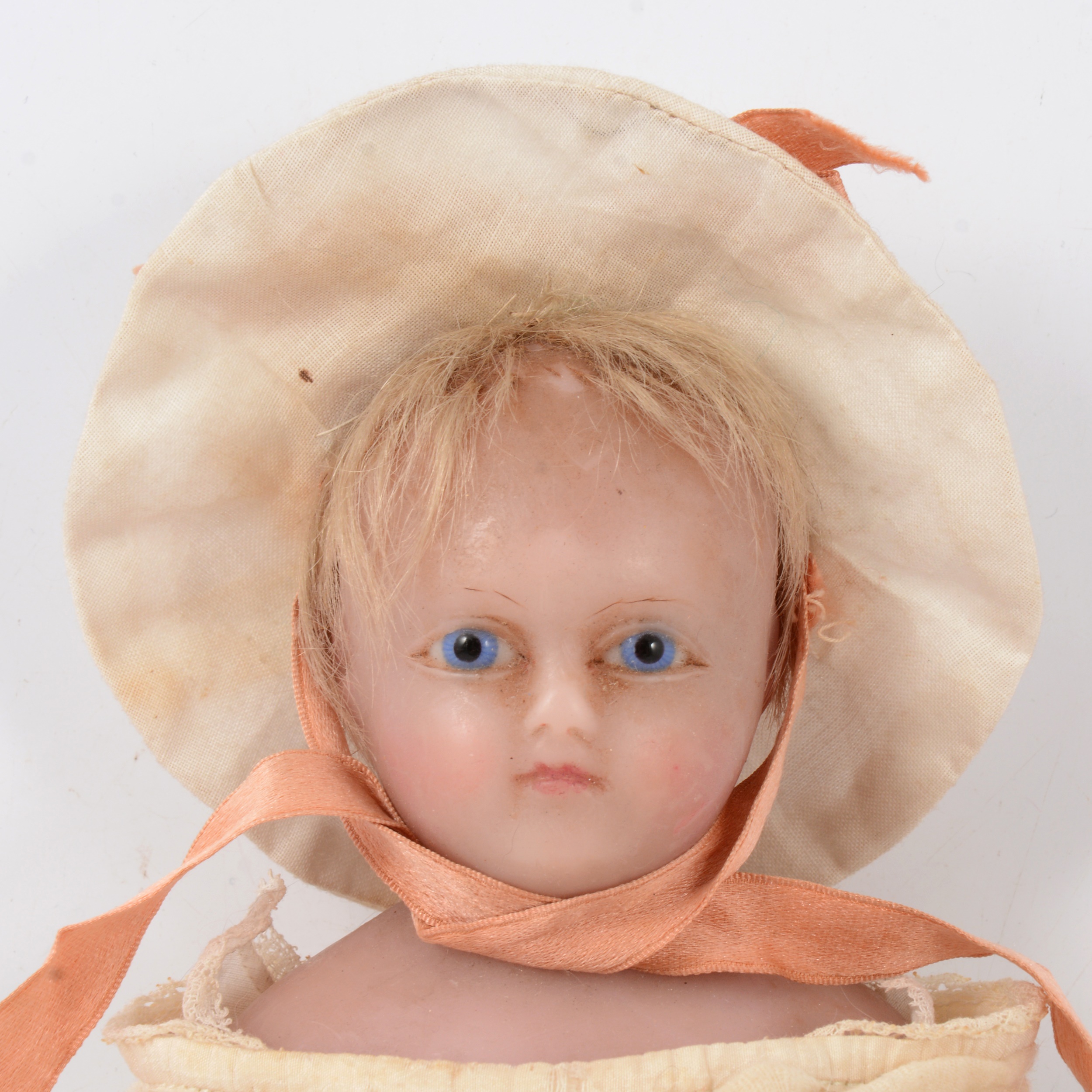 A Victorian poured wax doll, blue glass eyes, wax limbs, rag body, 37cm.