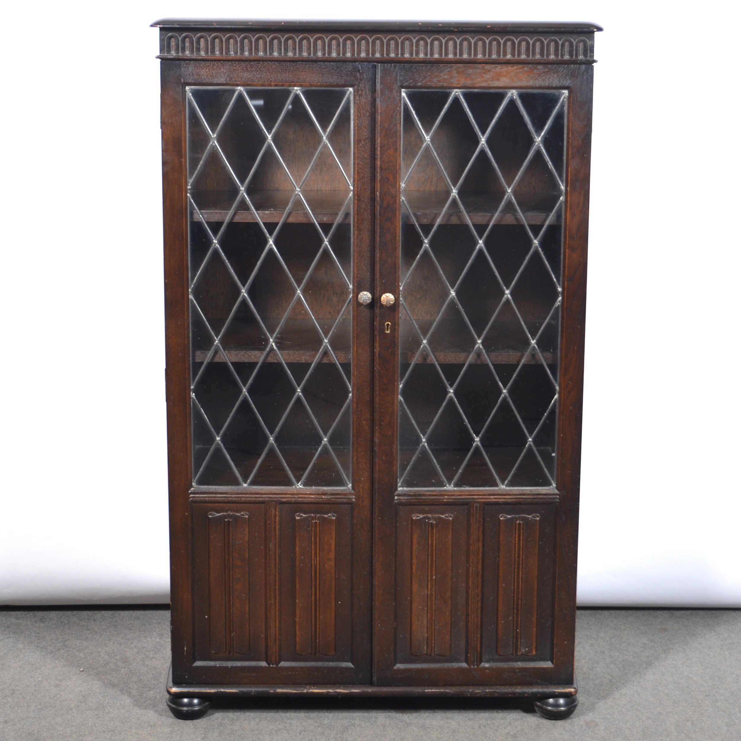 Two stained oak glazed bookcases and an open bookcase