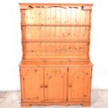 Modern pine kitchen dresser, together with a kitchen table and four chairs