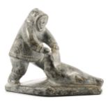 Inuit carving of an Eskimo seal hunter and seal.