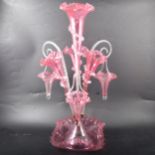 A cranberry glass epergne, central flute with three surrounding.