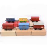 Six Hornby O gauge model railway vans with advertising